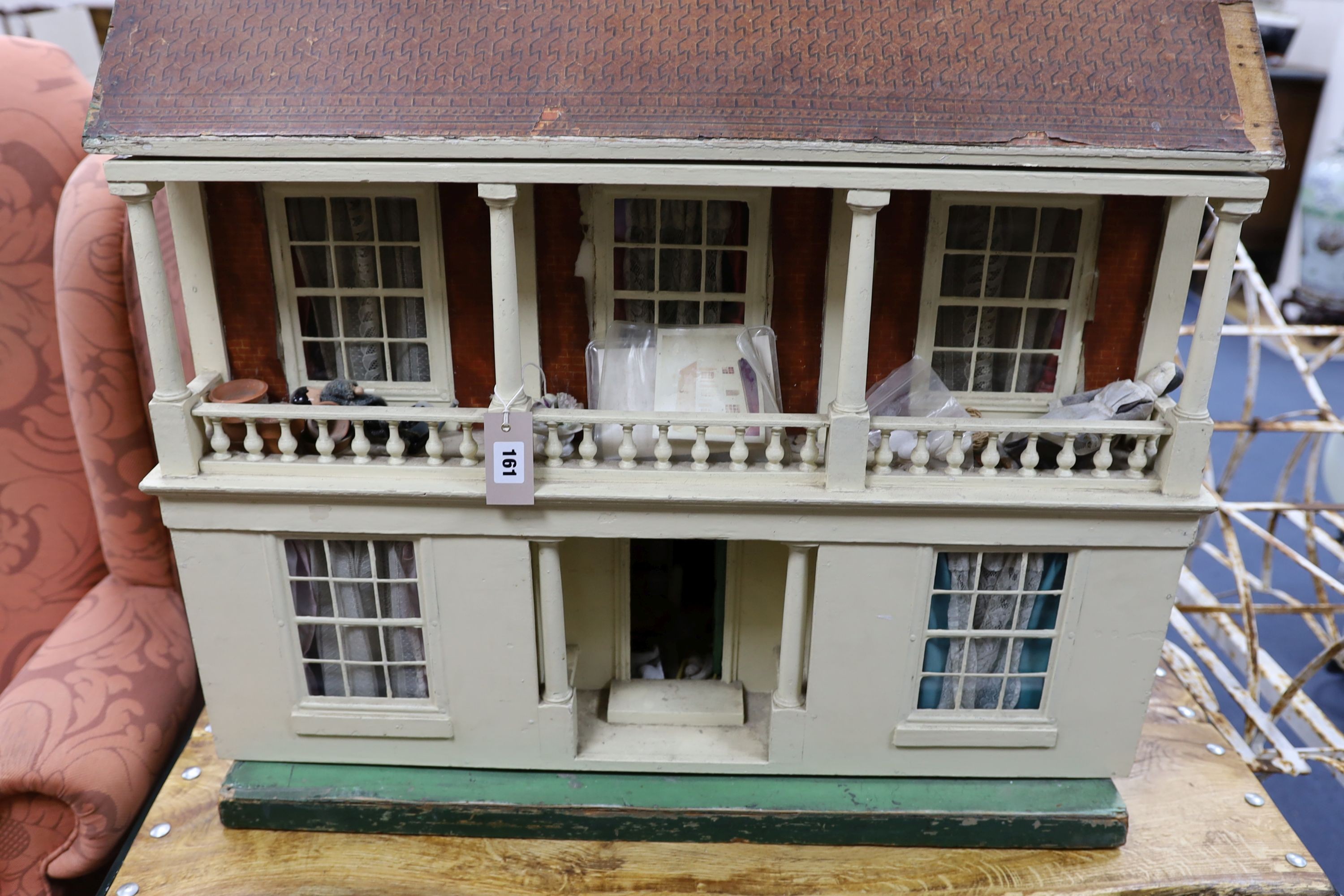 An early 20th century painted dolls house with accessories, width 82cm, height 84cm